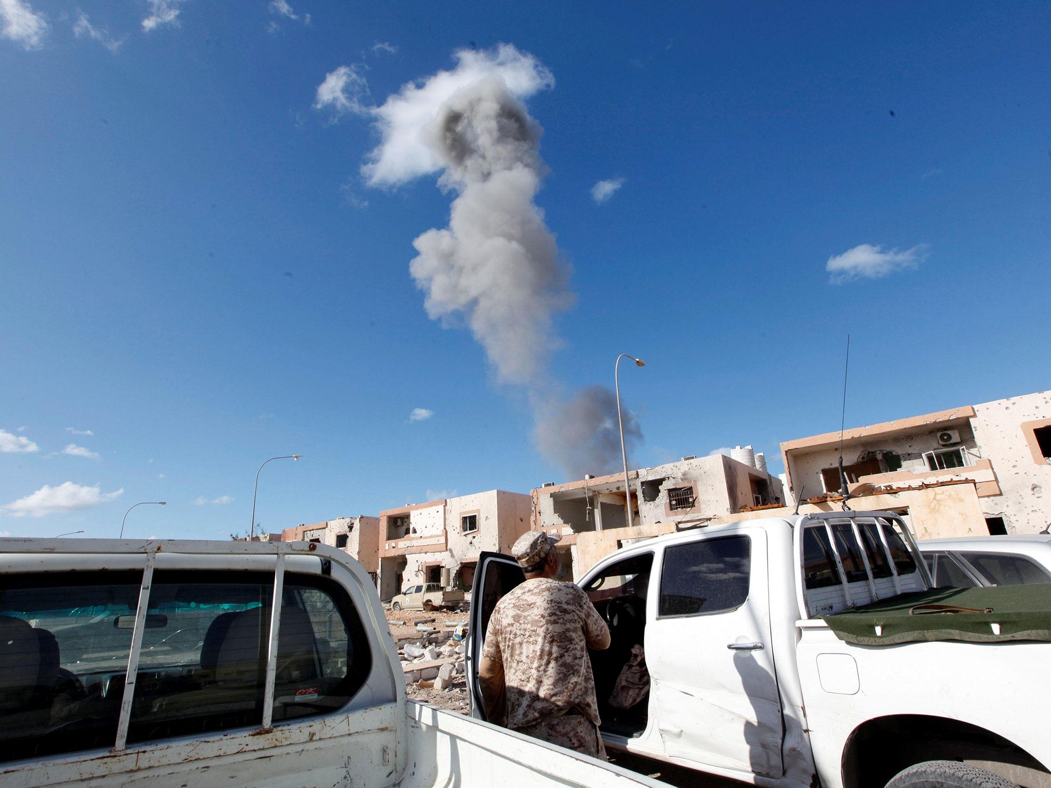 Smoke rises as fighters of Libyan forces allied with the UN-backed government advance against Isis holdouts in Ghiza Bahriya district in Sirte, Libya, 1 December, 2016