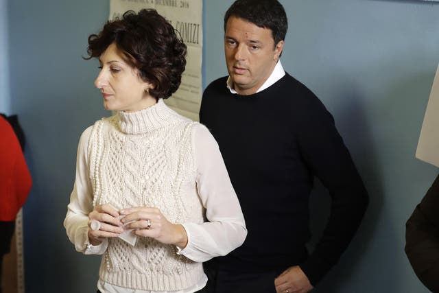 Italian Premier Matteo Renzi and his wife Agnese arrive at a polling station in Pontassieve