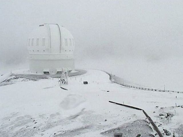 In this image made from webcam video provided by Canada-France-Hawaii Telescope, the CFHT telescope on the summit of Mauna Kea on Hawaii's Big Island is covered in snow