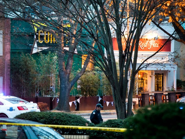 Police surround Comet Ping Pong after a man with an assault rifle entered the restaurant in Washington, D.C.