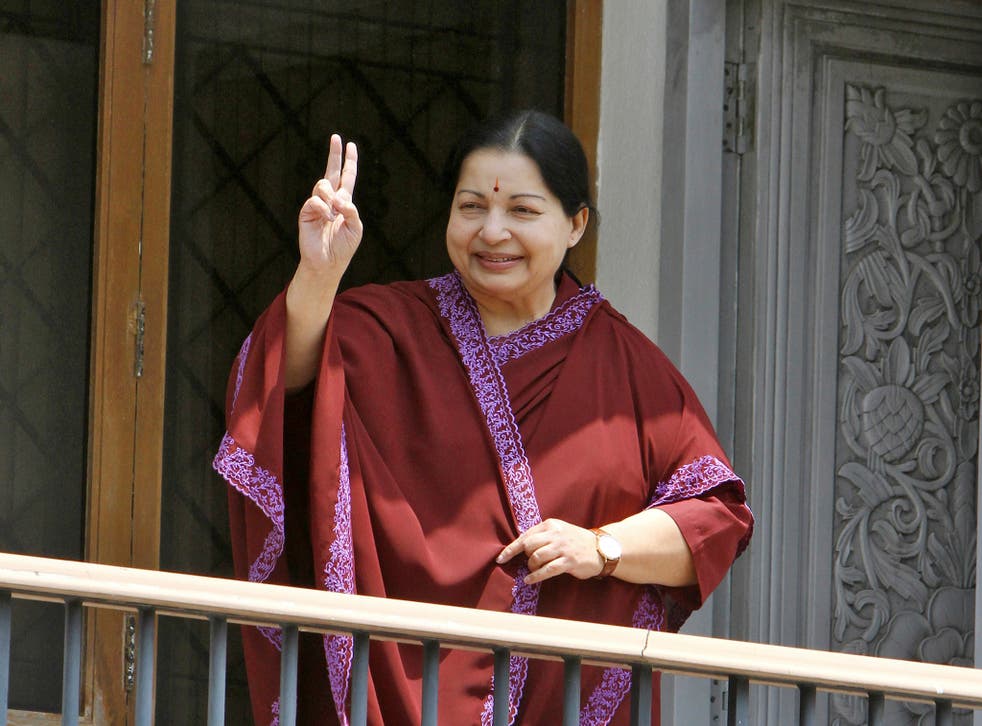 J. Jayalalithaa, leader of Anna Dravida Munetra Khazhgam (AIADMK) flashes a victory sign toward her supporters from the balcony of her residence after winning state election in the southern Indian city of Chennai