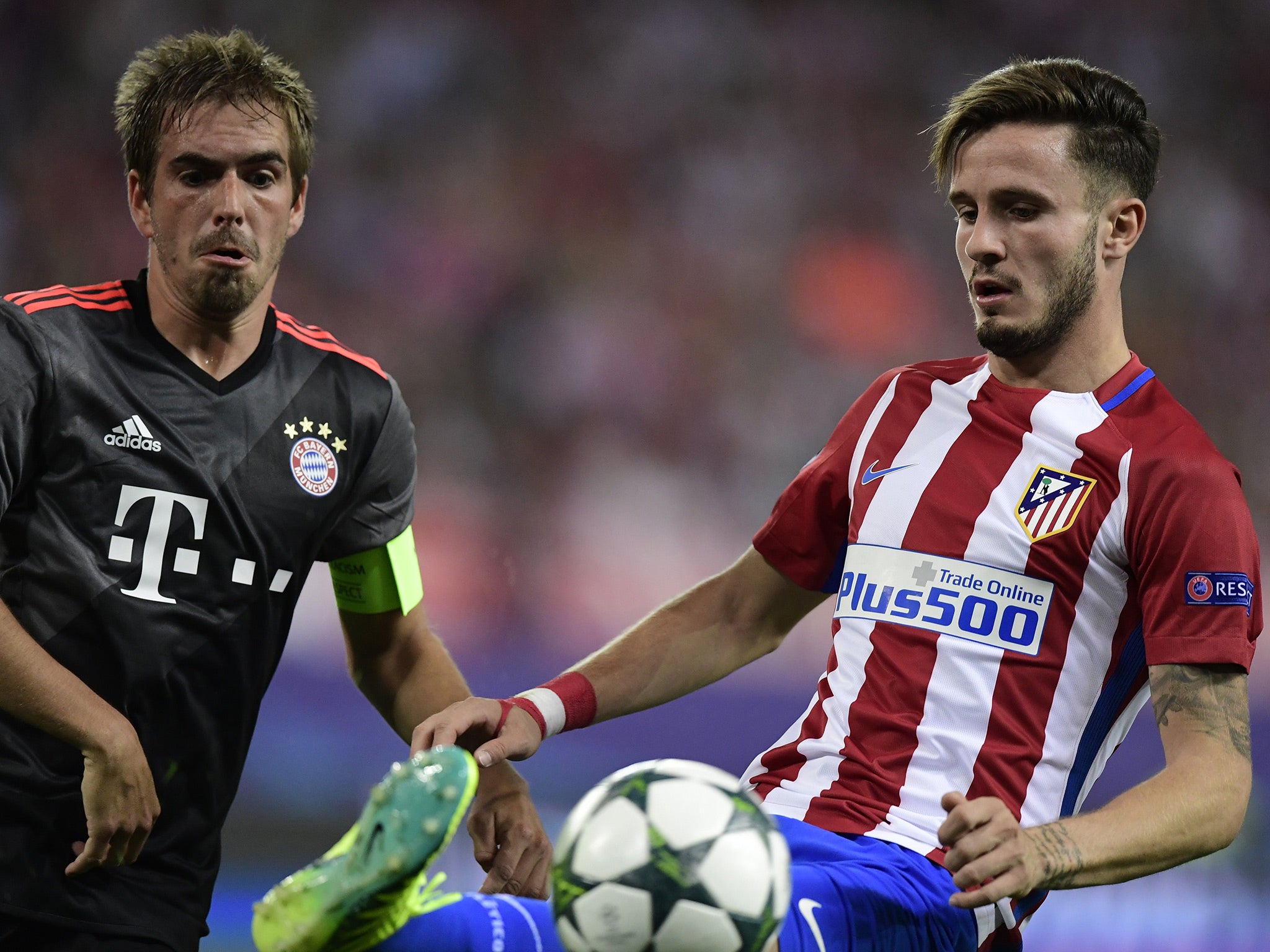 Lahm battles for the ball with Atletico's Saul