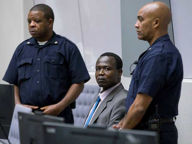 Dominic Ongwen, a senior commander in the Lord's Resistance Army, whose fugitive leader Kony is one of the world's most-wanted war crimes suspects, is flanked by two security guards as he sits in the court room of the International Court in The Hague, Netherlands