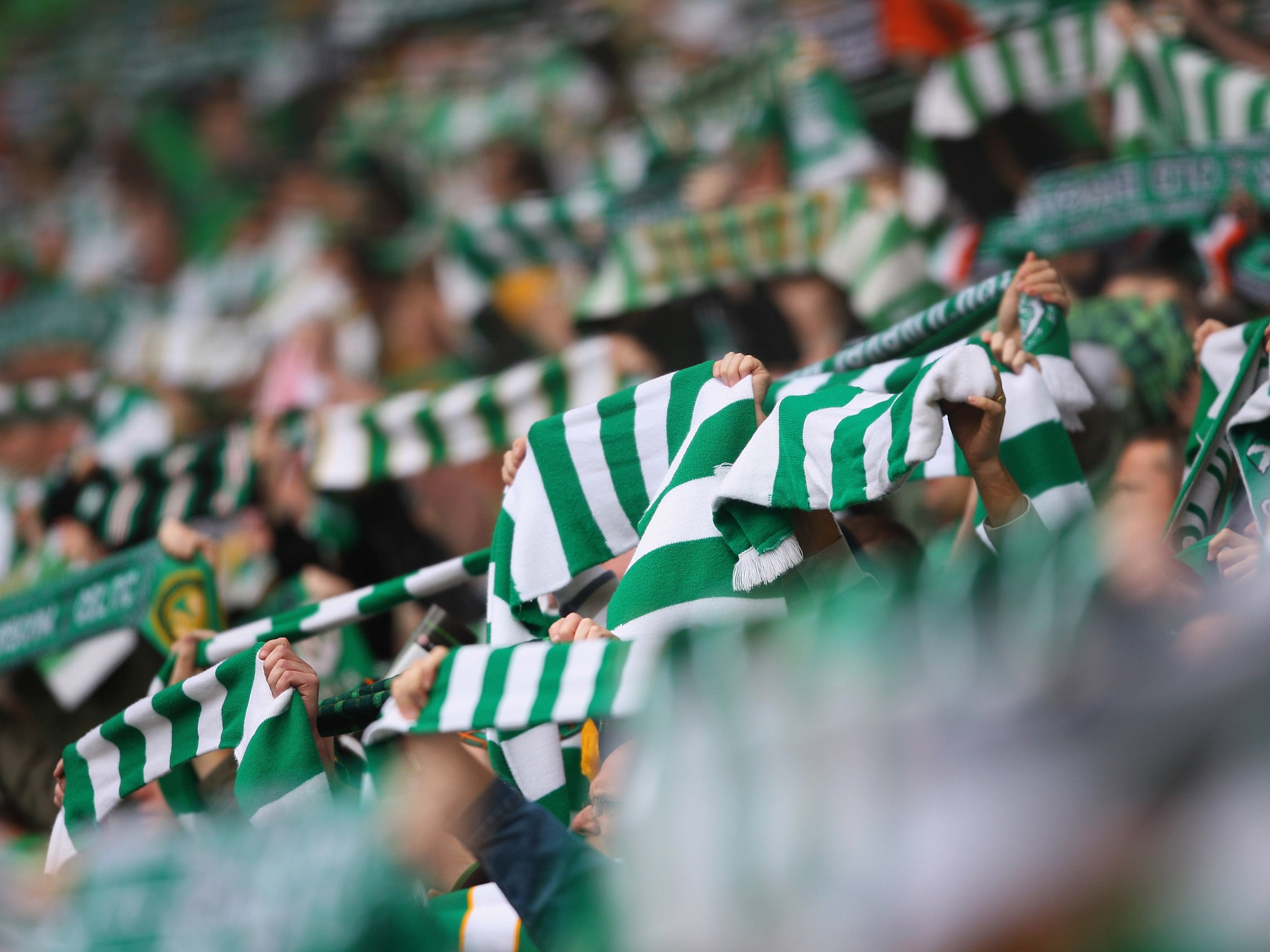 Celtic supporters lift scarves at Celtic Park