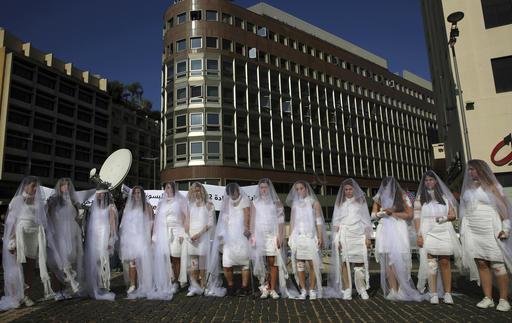 Women dresses as brides wrapped in bloody bandages protest the law in Beirut