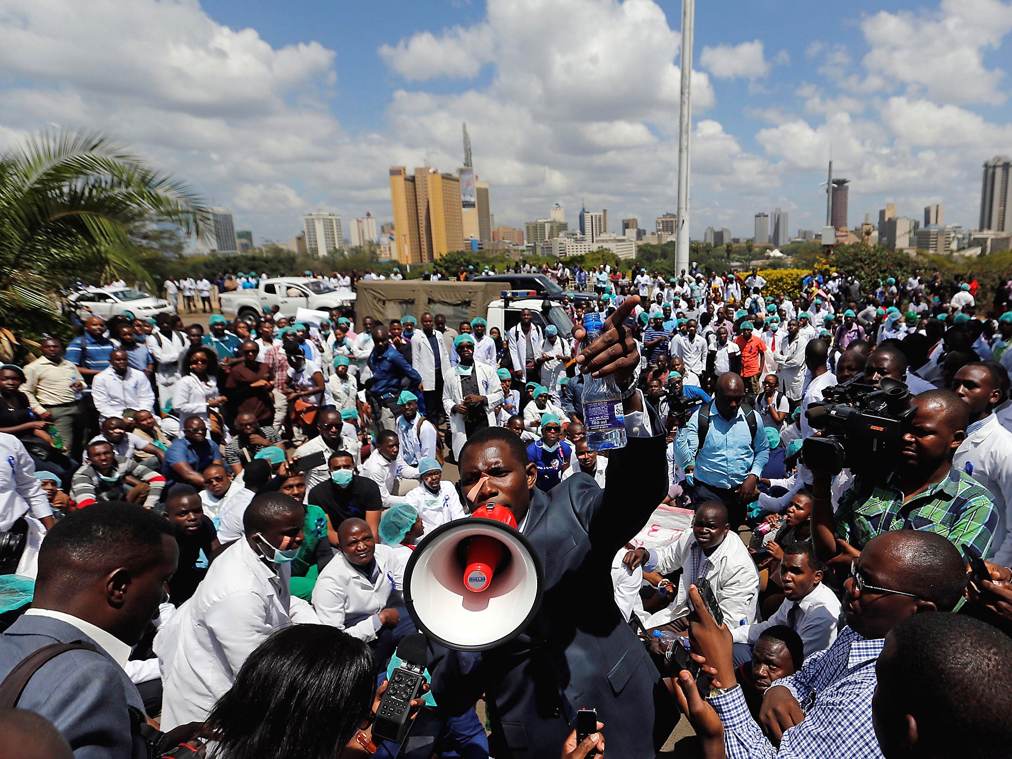 Ouma Oluga, Secretary-General of the Kenya Medical Practitioners, Pharmacists and Dentist Union (KMPDU), addresses doctors during a strike to demand fulfilment of a 2013 agreement between their union and the government that would raise their pay and improve working conditions outside Ministry of Health headquarters in Nairobi, Kenya