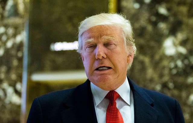 US President-elect Donald Trump exits elevators to talk with the media at Trump Tower on December 6, 2016 in New York.