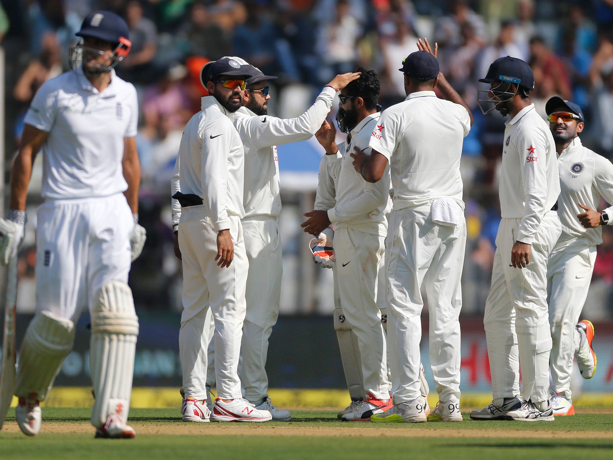 India's players celebrate following Alastair's Cook's dismissal