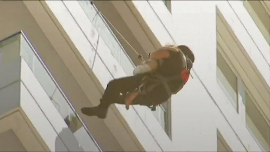 Moment firefighter rescues baby from burning building captured on