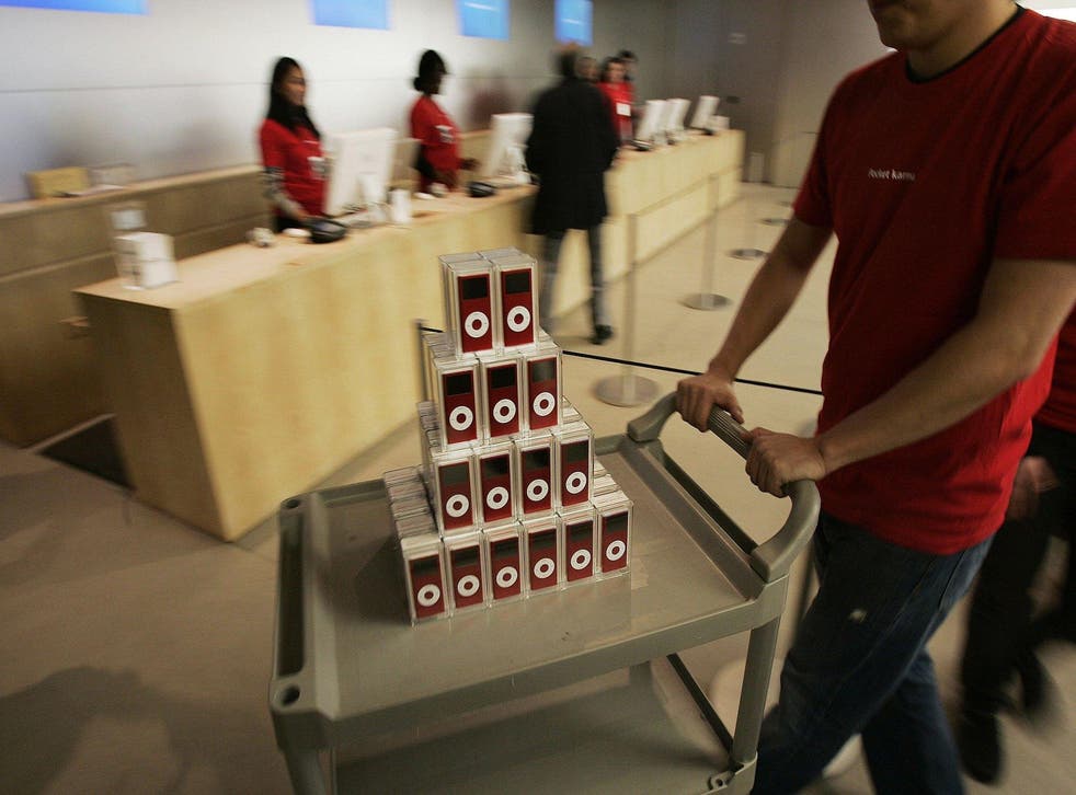 An Apple store employee pushes a cart of (PRODUCT) RED iPod nanos sit in the Apple store in midtown Manhattan October 13, 2006 in New York