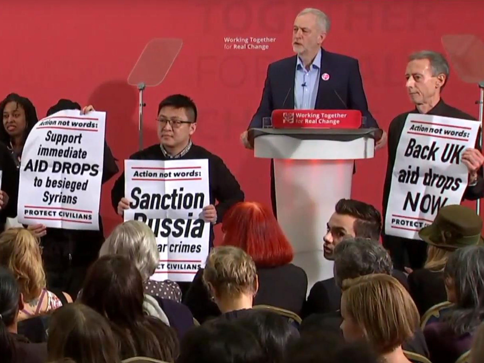 Peter Tatchell (right) leads protesters disrupting a speech by Jeremy Corbyn to demand more action in Aleppo, in London on 10 December