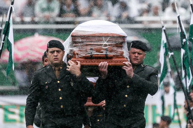 Air Force troops carry coffin of one of the victims at Arena Conda stadium in Chapeco, Brazil