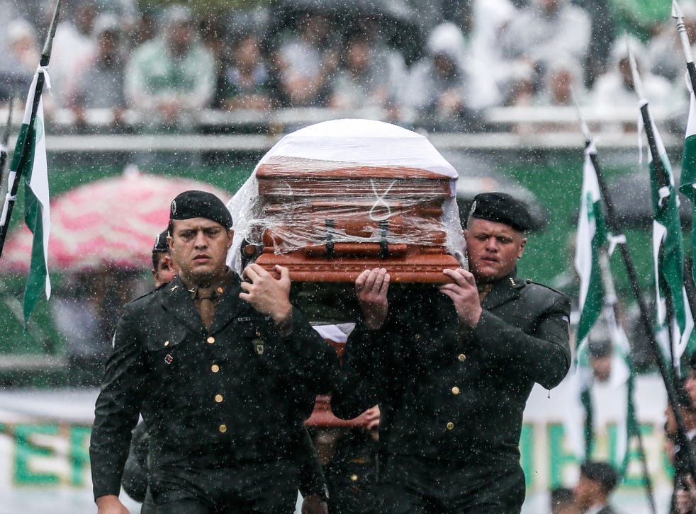 Air Force troops carry coffin of one of the victims at Arena Conda stadium in Chapeco, Brazil