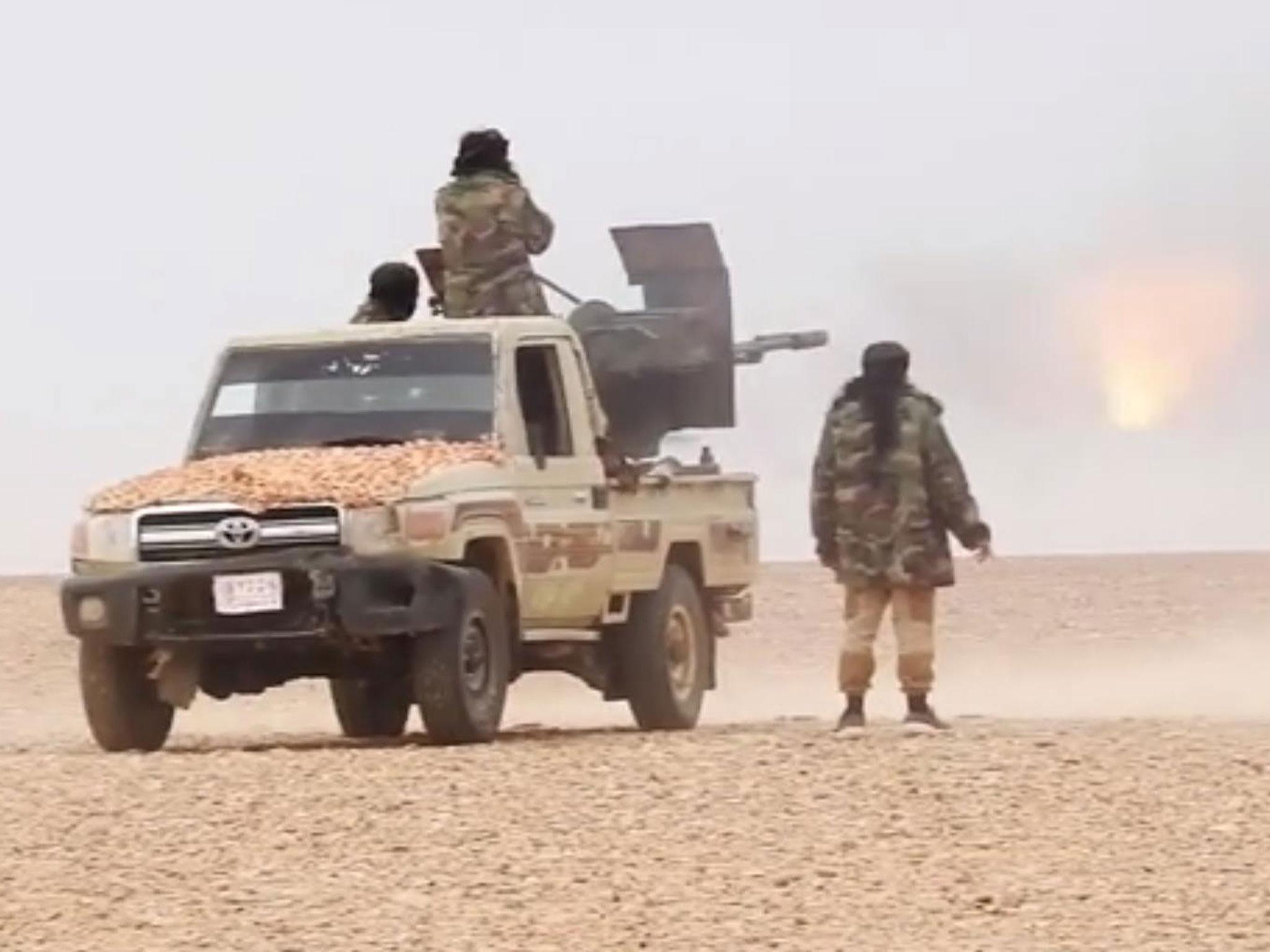 Isis fighters attacking the Syrian army on the outskirts of Palmyra on 9 December