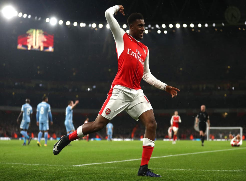 Alex Iwobi celebrates as his goal sees Arsenal top the league