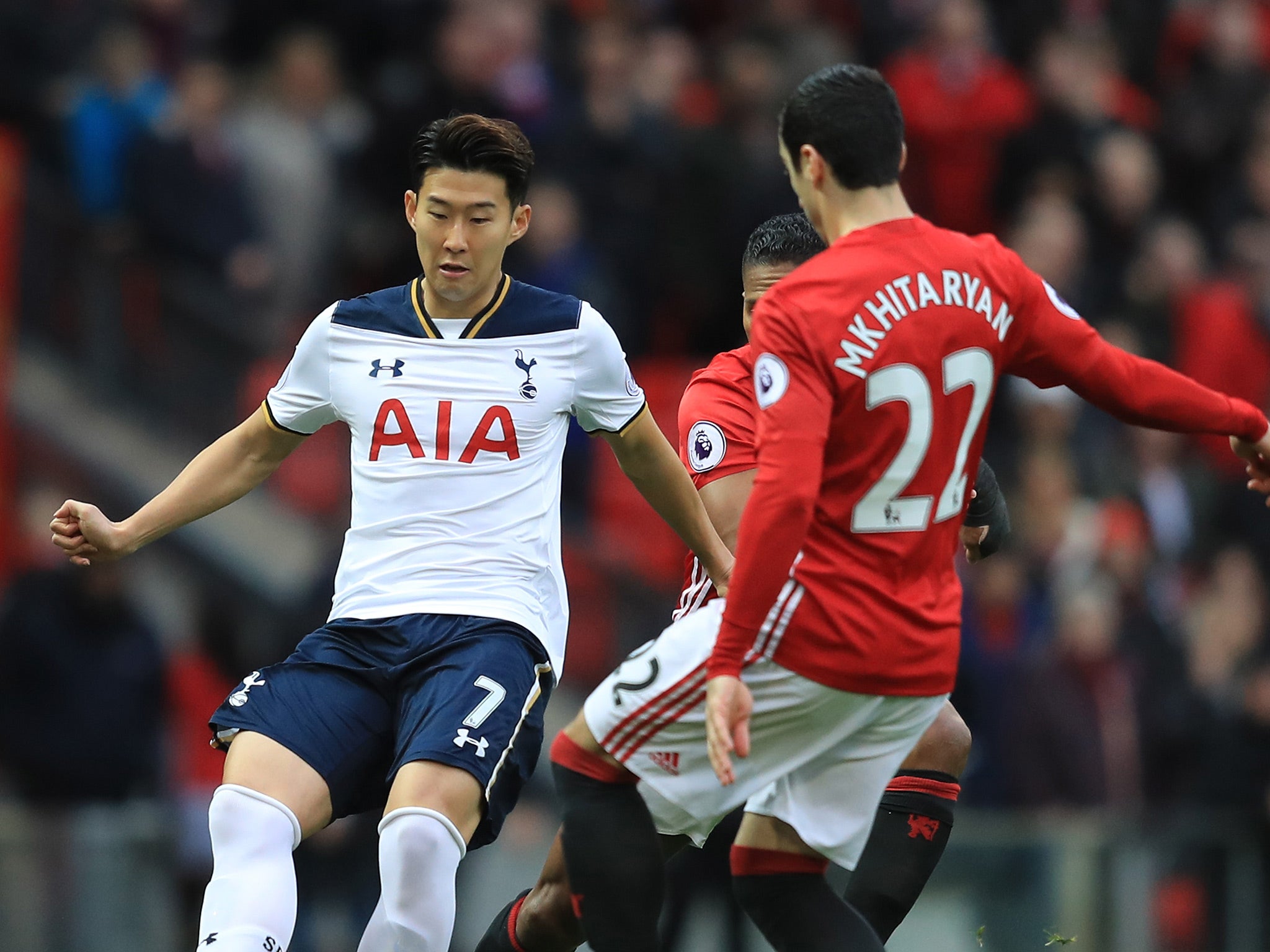 Son and Mkhitaryan battle for the ball in the opening stages at Old Trafford