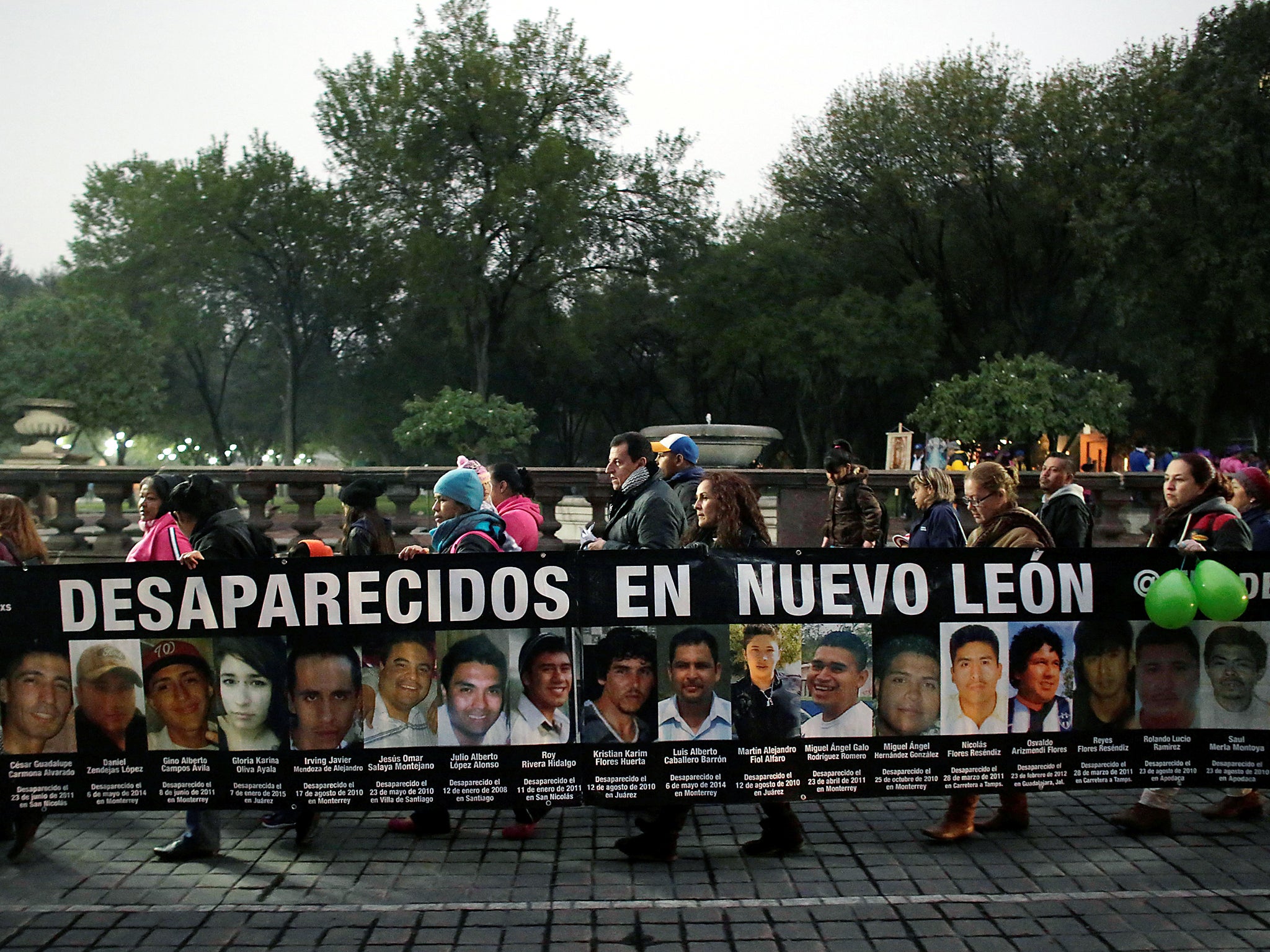 Demonstrators hold a banner with images of their relatives, who they say went missing or were killed, during a demonstration demanding justice for the victims of violence, in Monterrey, Nuevo Leon state, Mexico