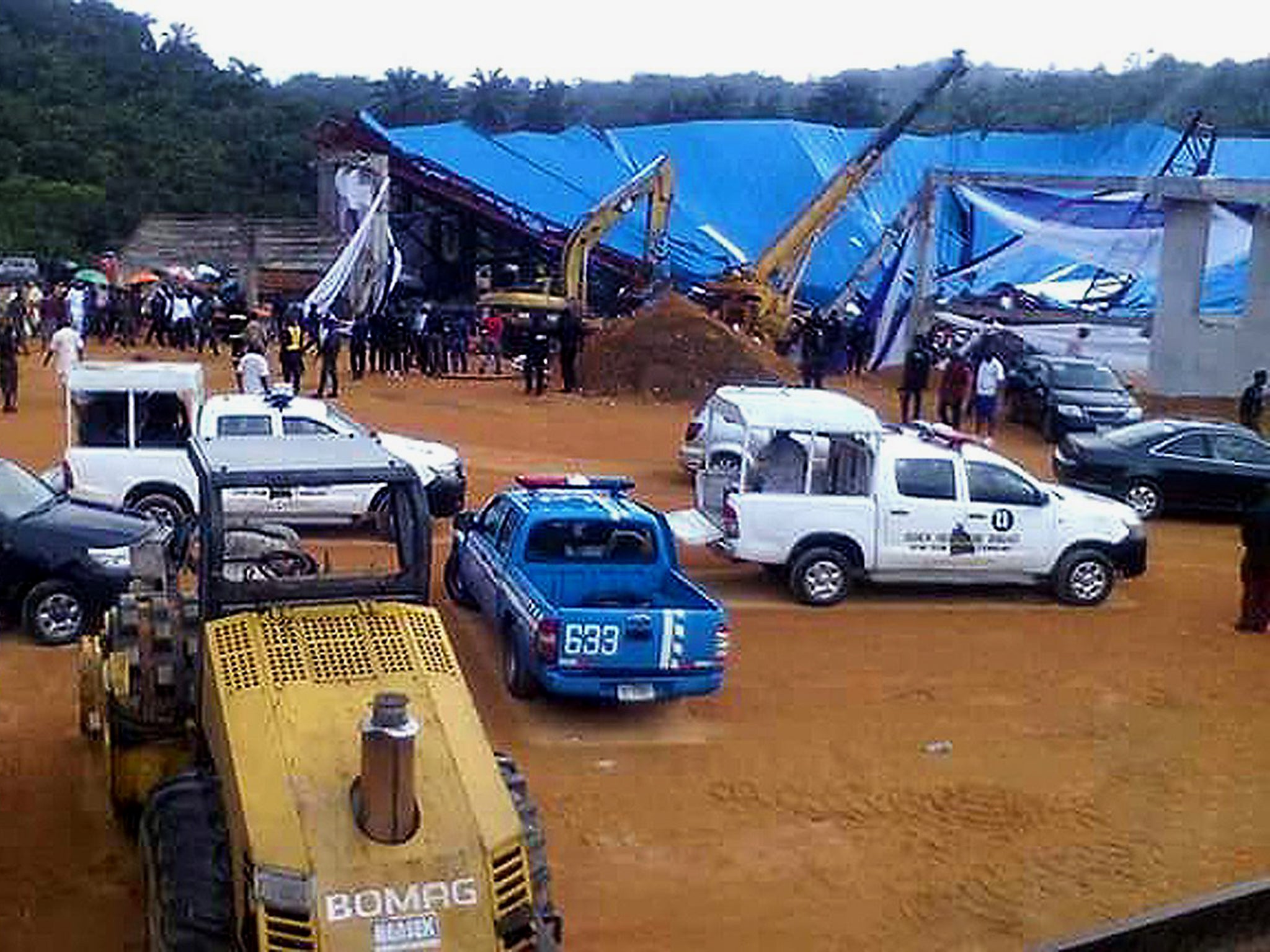 Rescue workers tend to the scene of a church roof collapse at Reigners Bible Church in Uyo, Nigeria