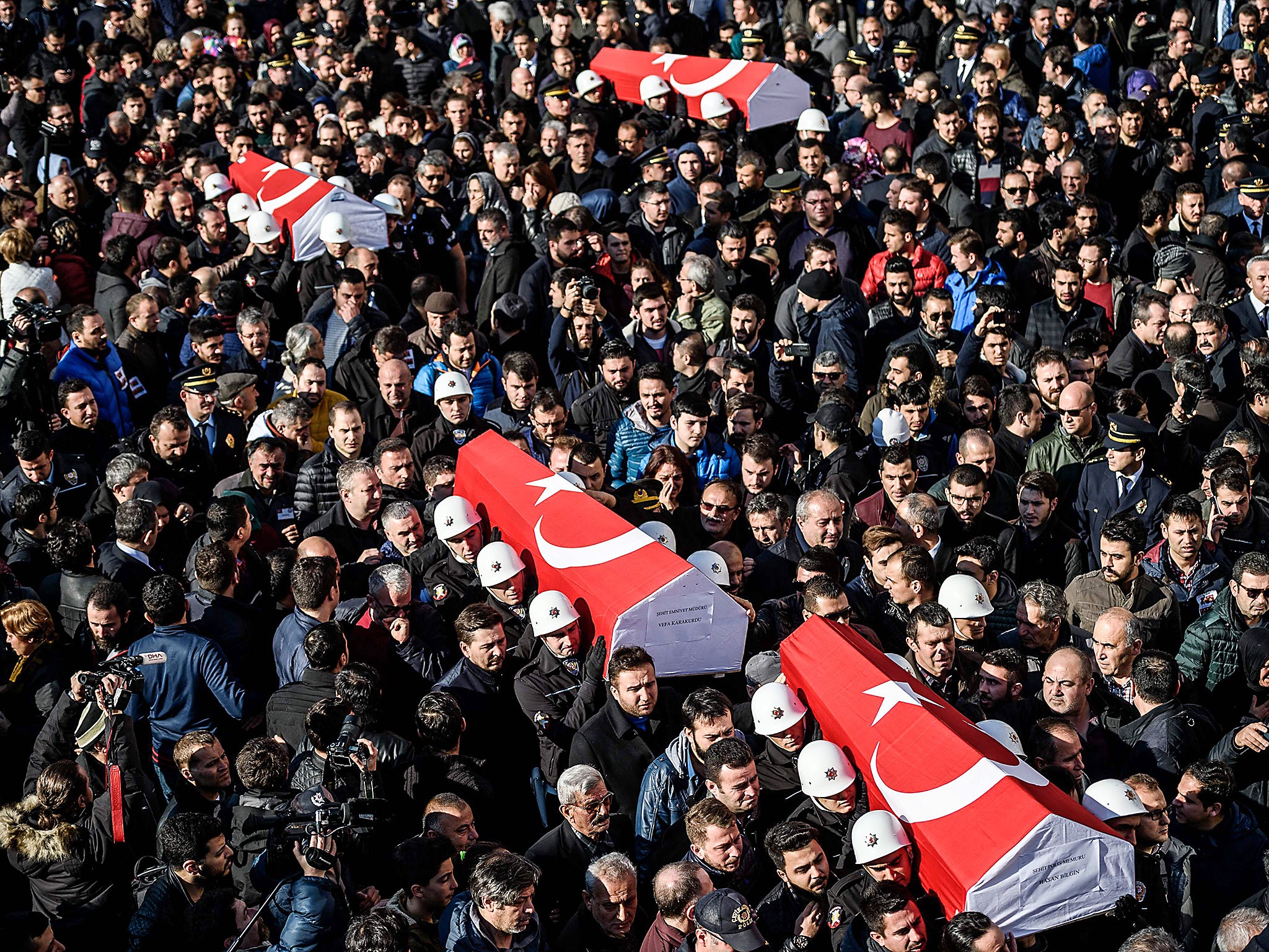 Turkish police officers carry the coffins of comrades during a funeral cerenomy at Istanbul's police headquarters