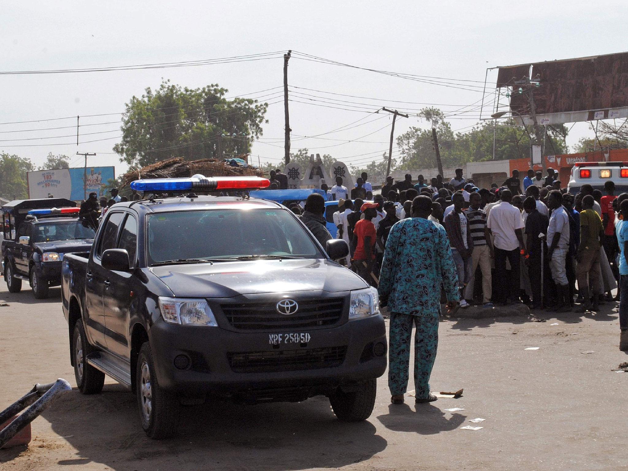 Emergency services, police and residents gather at the scene of a double suicide bomb attack on a market in Maiduguri, 11 December, 2016