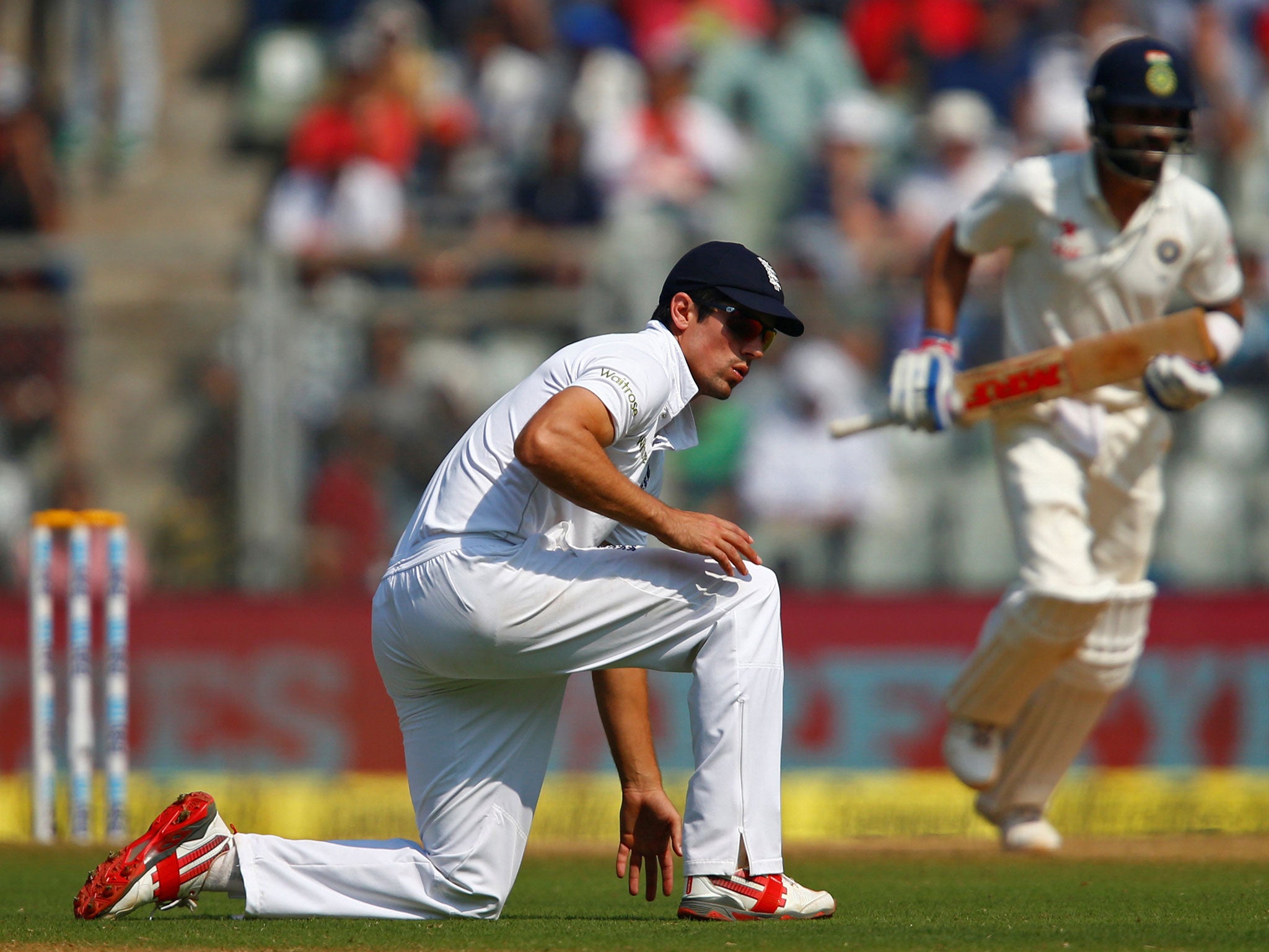 Cook looks on as Virat Kohli runs between wickets