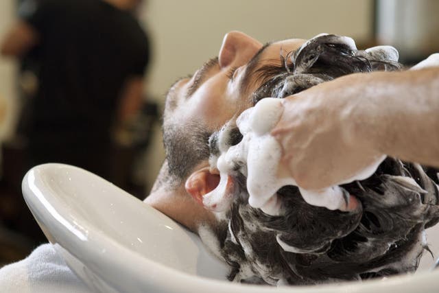 Stock image of a man having his hair washed at a salon