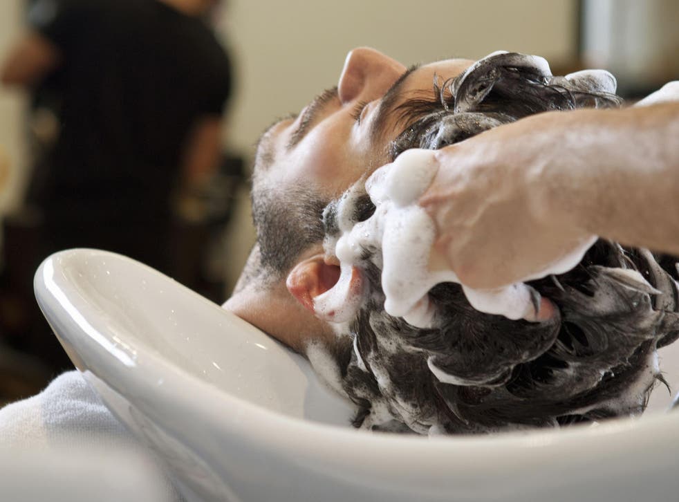 Stock image of a man having his hair washed at a salon