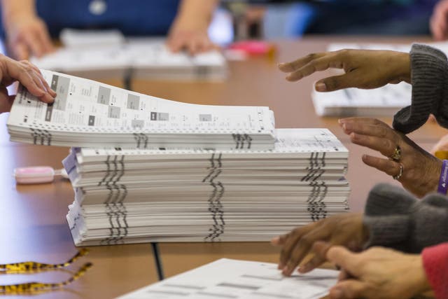 Tabulators work on recounting presidential ballots in Dane County, Wisconsin, in December