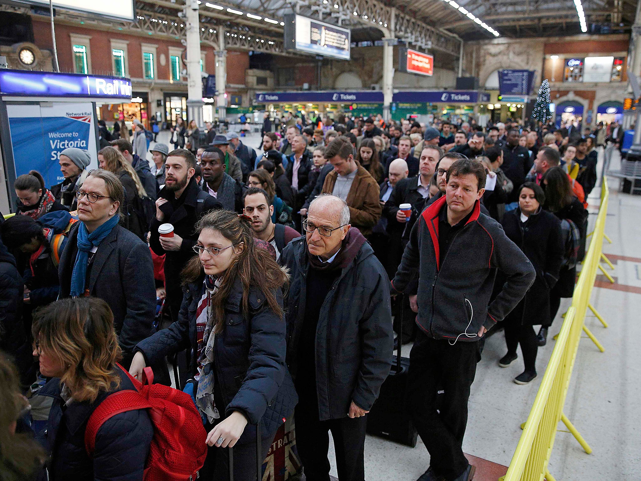 Passengers queue for a reduced Gatwick Express service during the Southern railway strike at Victoria station in London