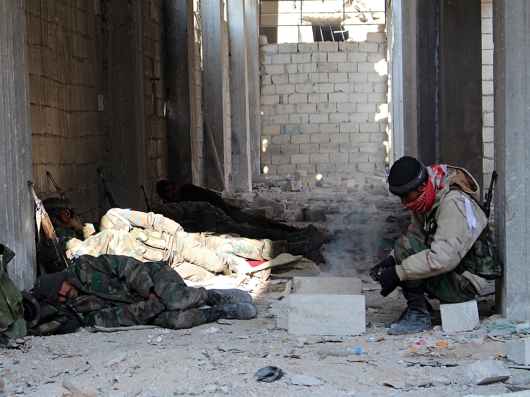Syrian soldiers rest follow winning control of Sheik Saeed neighborhood in Aleppo, Syria, on December 12 2016