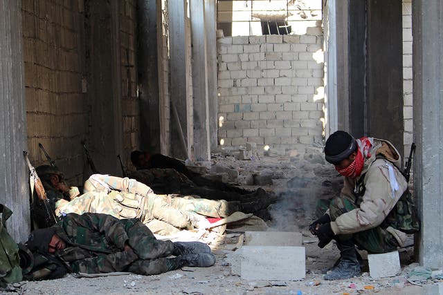 Syrian soldiers rest follow winning control of Sheik Saeed neighborhood in Aleppo, Syria, on December 12 2016