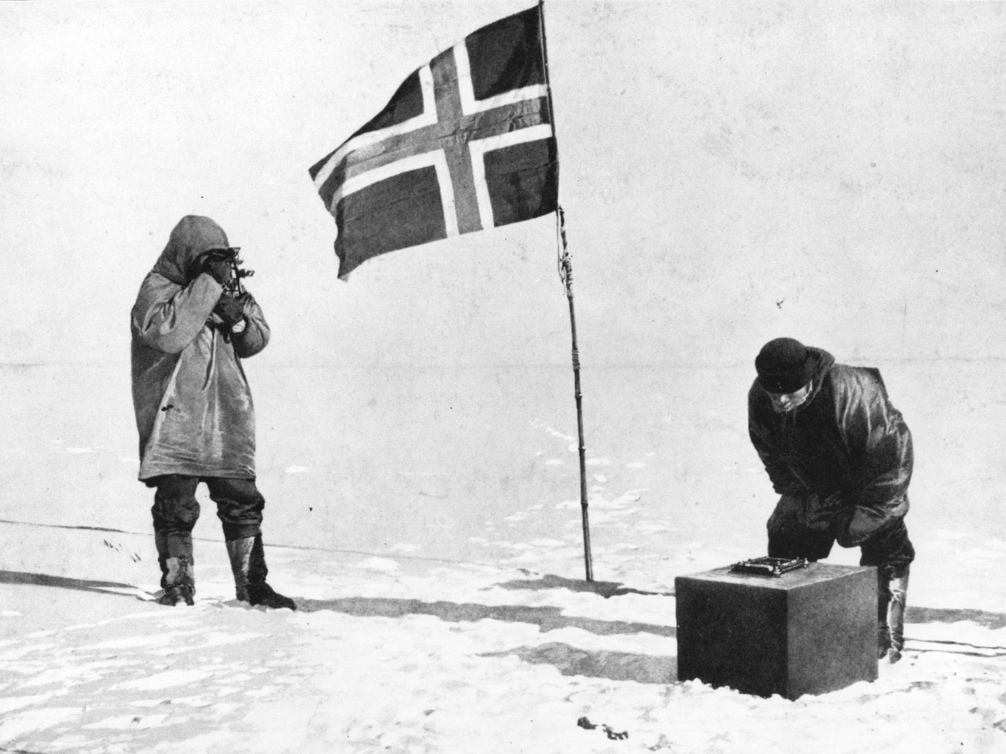 Roald Amundsen taking in the sights at the South Pole, beside the Norwegian flag