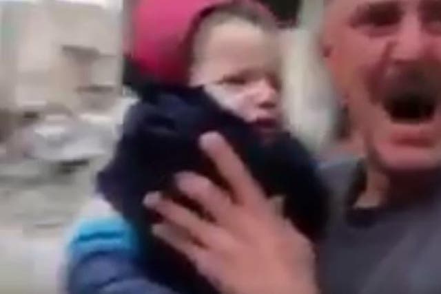 A crying man tells a child 'Daddy has gone to paradise' in rebel-held east Aleppo on Tuesday December 13 2016