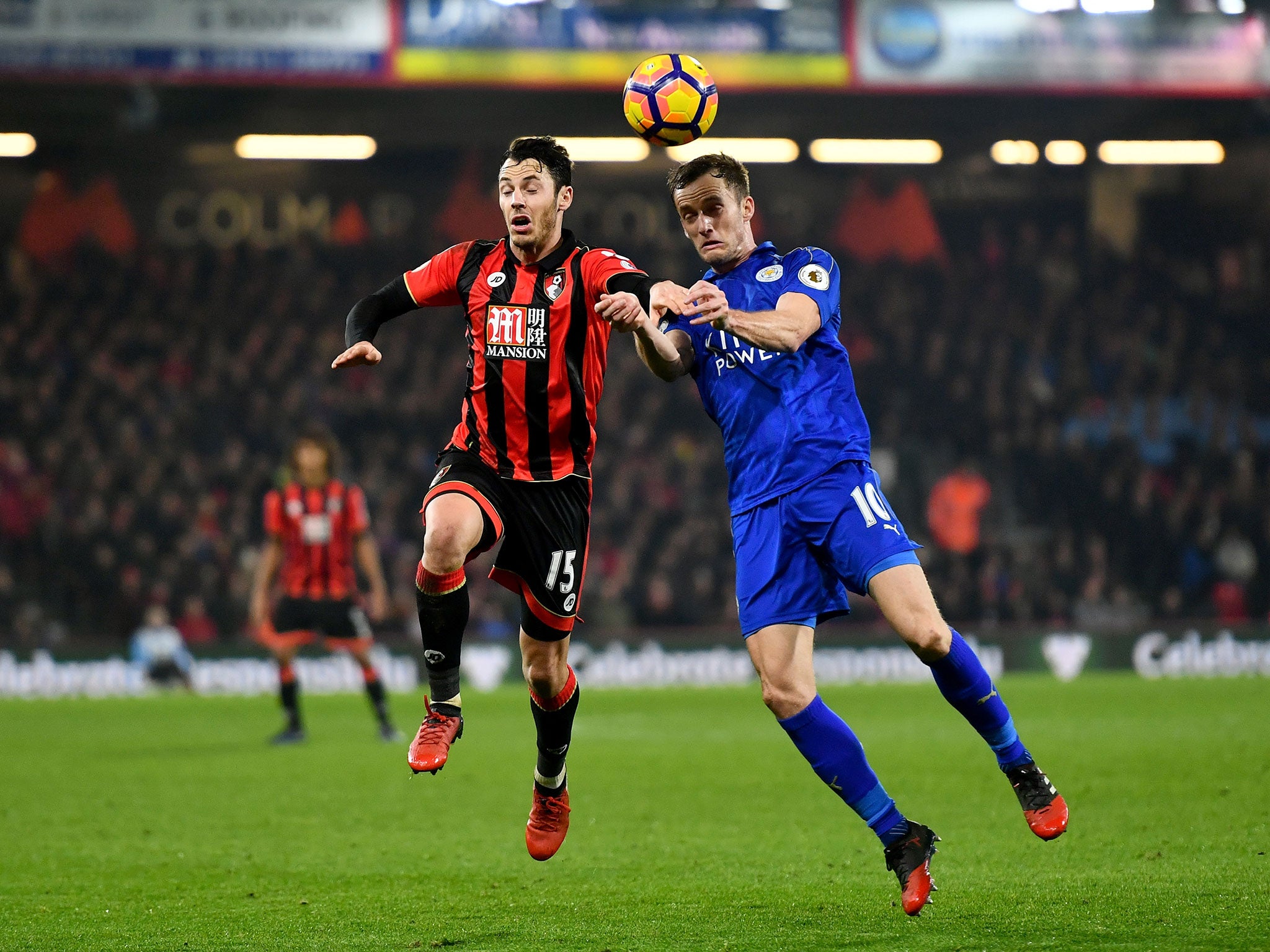 Adam Smith and Andy King compete for a high ball