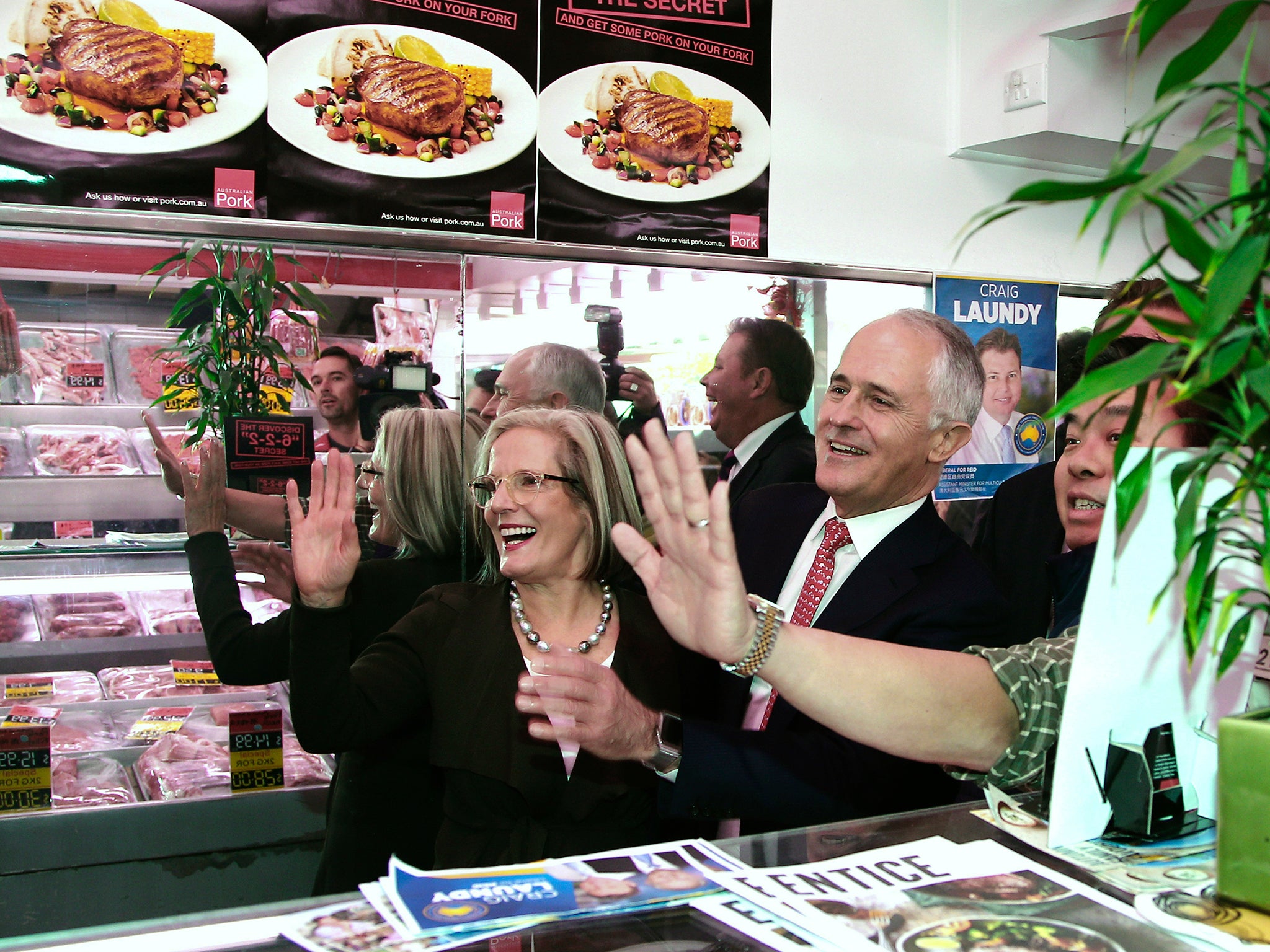 Australia's Prime Minister Malcolm Turnbull greets customers in a Sydney butcher's shop on his way to pick up a 'democracy sausage'