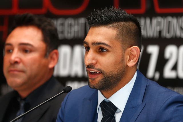 Amir Khan has said he will stick by his wife after a family feud broke out