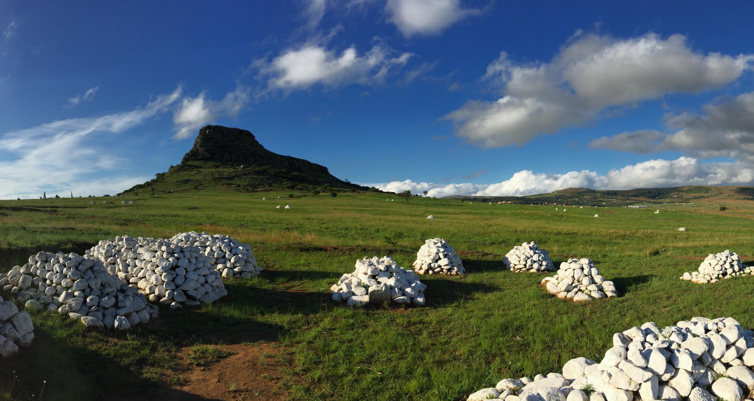 Mounds of white stone mark the remains of unnamed British soldiers at Isandlwana