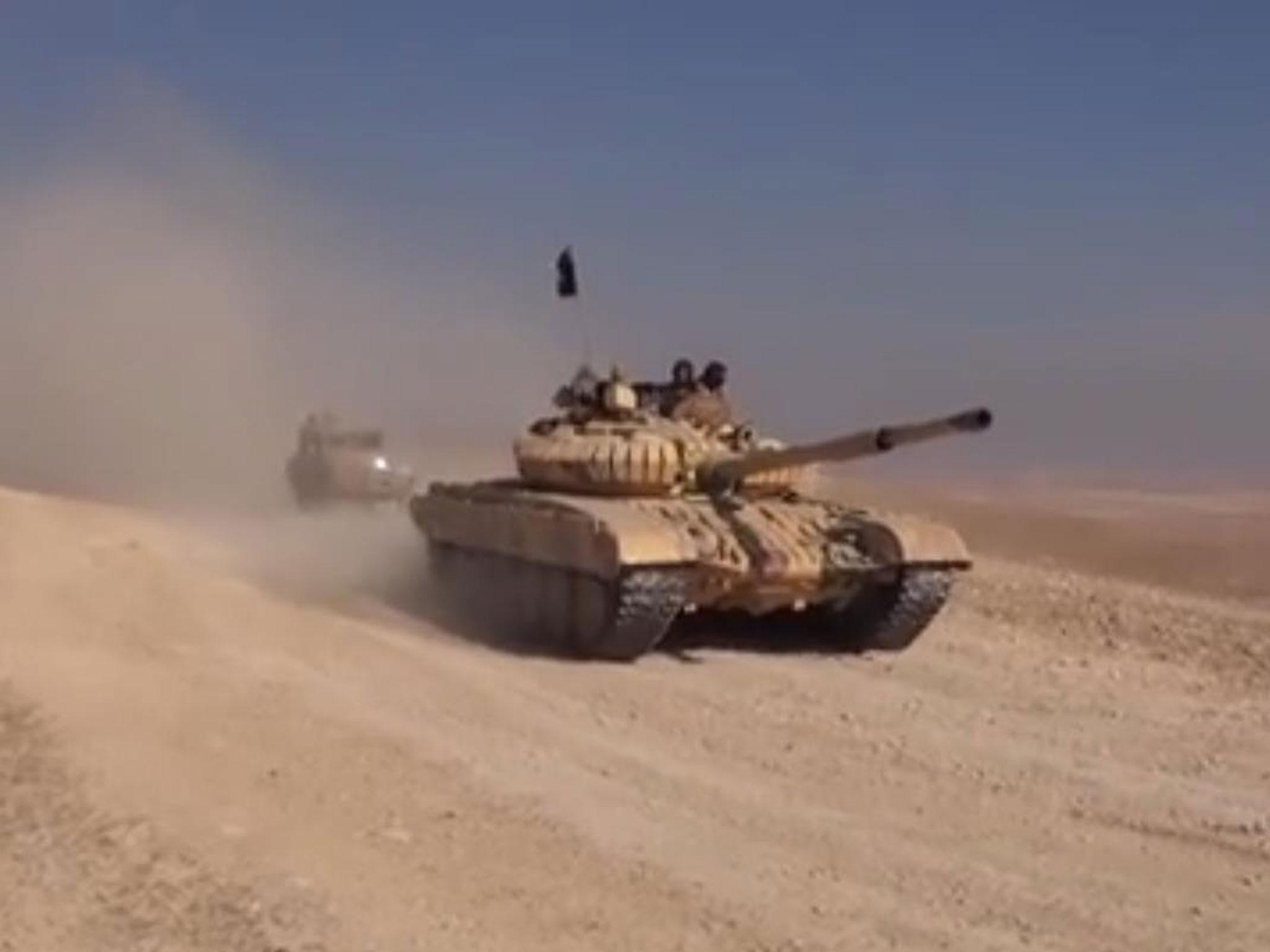 Isis fighters advancing towards the T4 air base near Palmyra in a Syrian tank on 13 December