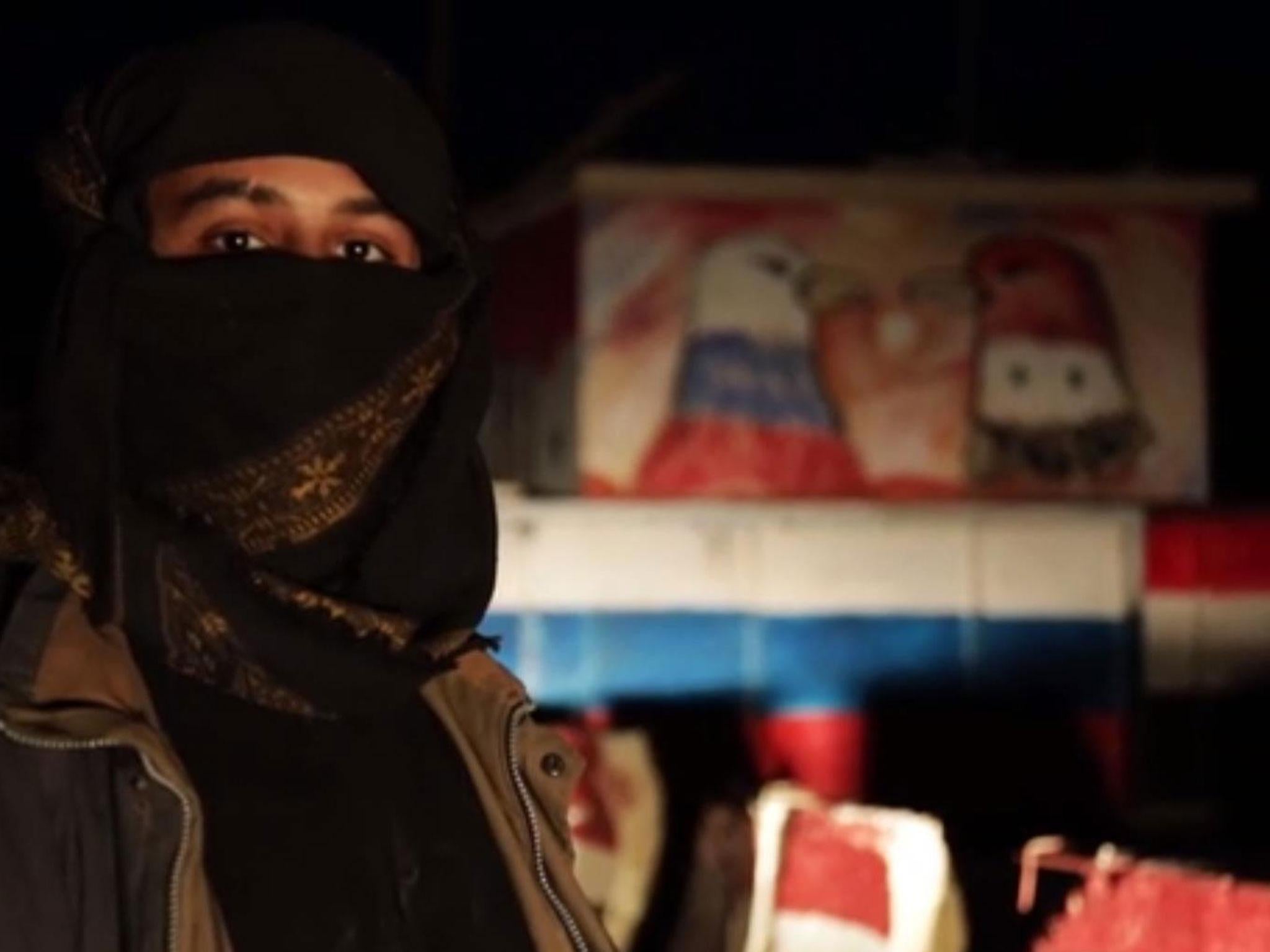 An Isis militant appearing in a propaganda video at a Russian base in the Syrian city of Palmyra in December