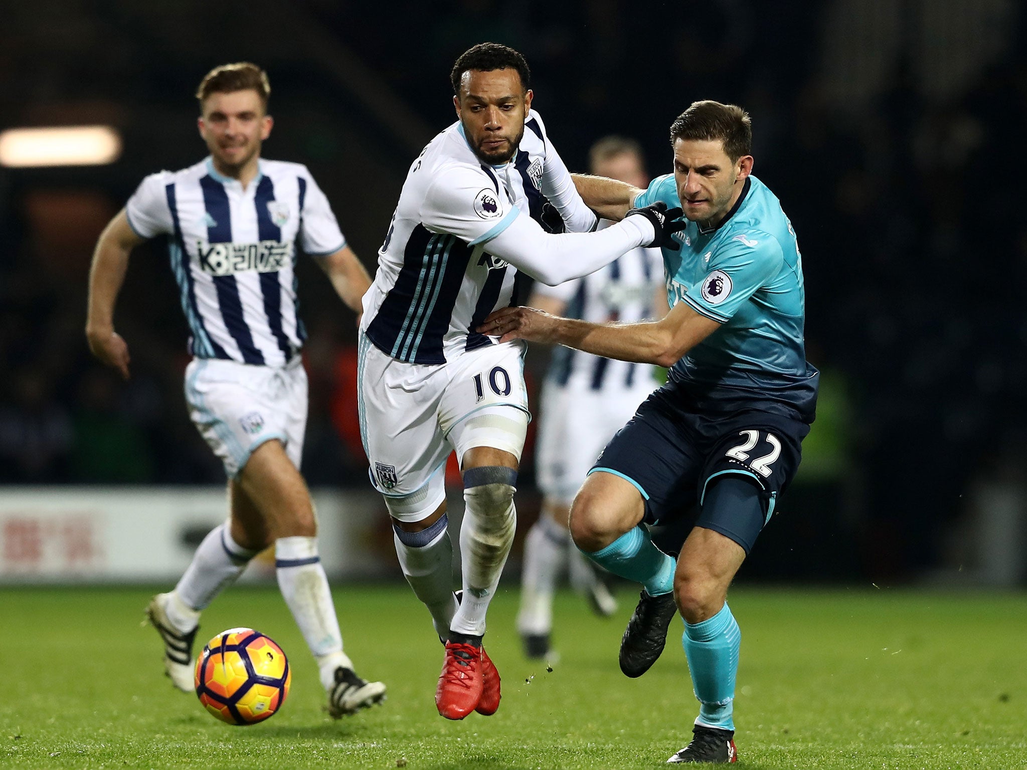 Matt Phillips and Angel Rangel vie for the ball