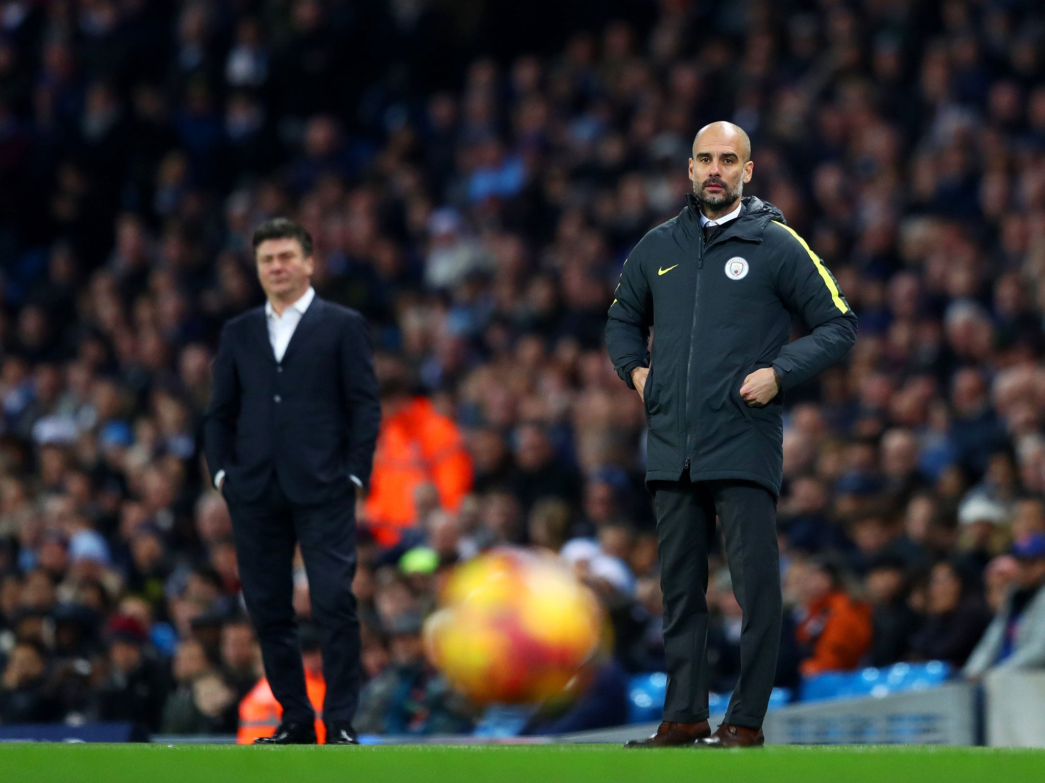 Pep Guardiola looks on from the sidelines during at the Etihad Stadium