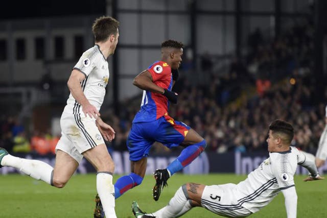 Marcos Rojo slides in on Wilfried Zaha with a two-footed tackle that Alan Pardew said deserved a red card