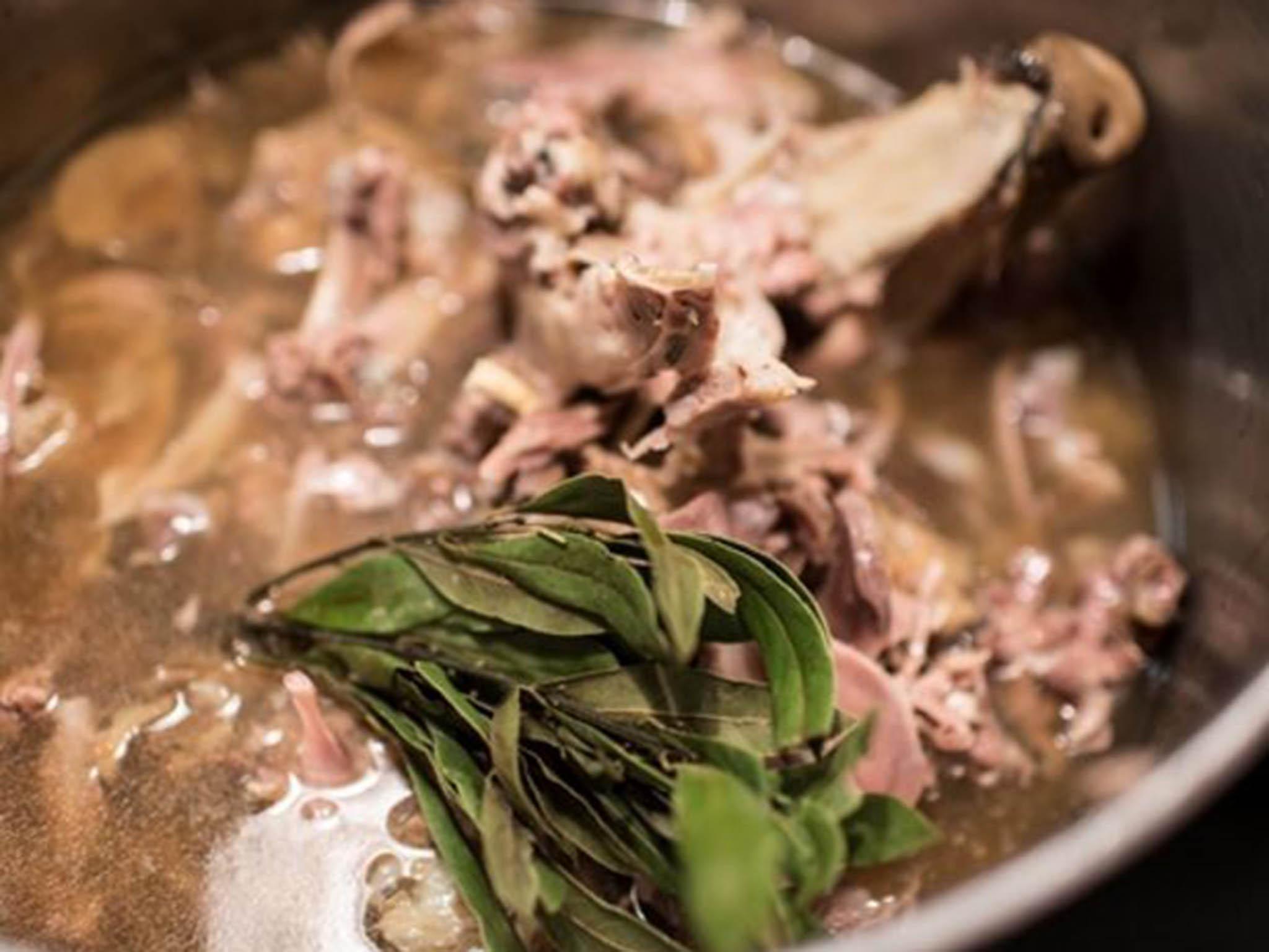 All the bones and brains are boiled up with herbs and reduced into a thick, incredibly porky sauce