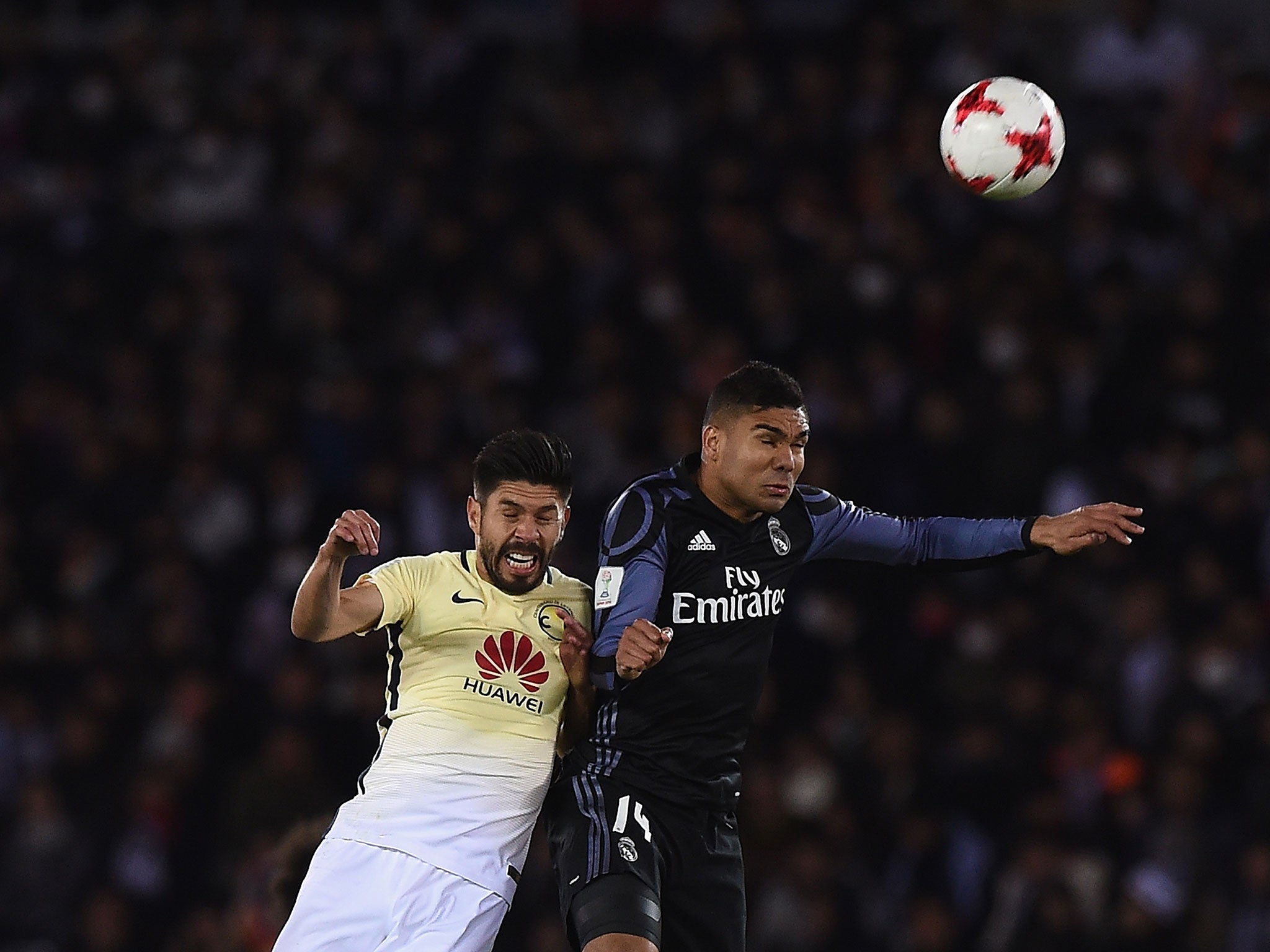 Casemiro and Oribe Peralta compete for a high ball