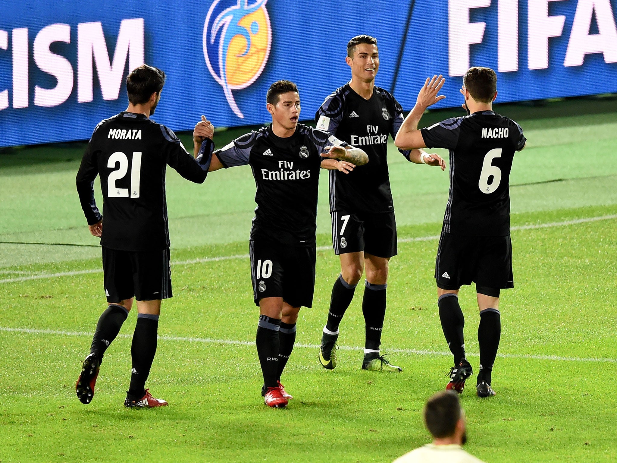 Real Madrid's players congratulate Cristiano Ronaldo on his late goal at the Nissan Stadium