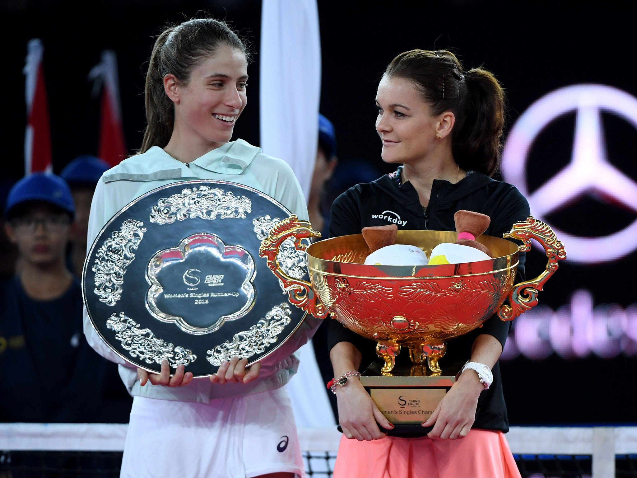 Konta poses with Agnieszka Radwanska during the awards ceremony after the women's singles final of the China Open tennis tournament in Beijing on October 9, 2016. The Briton was runner-up to the Pole