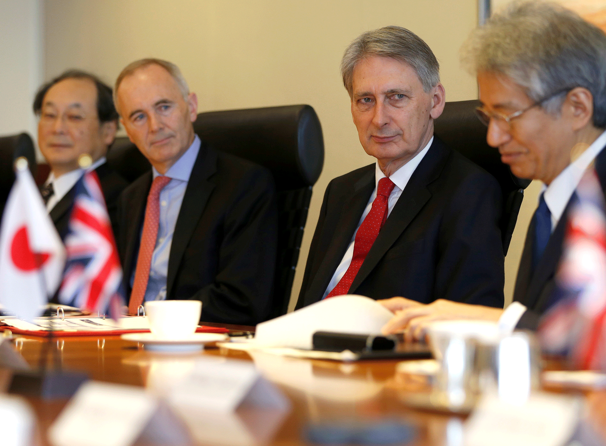 Chancellor Philip Hammond, flanked by British Ambassador to Japan Tim Hitchens, attends a meeting with CEOs and board members of Japanese financial institutions in Tokyo