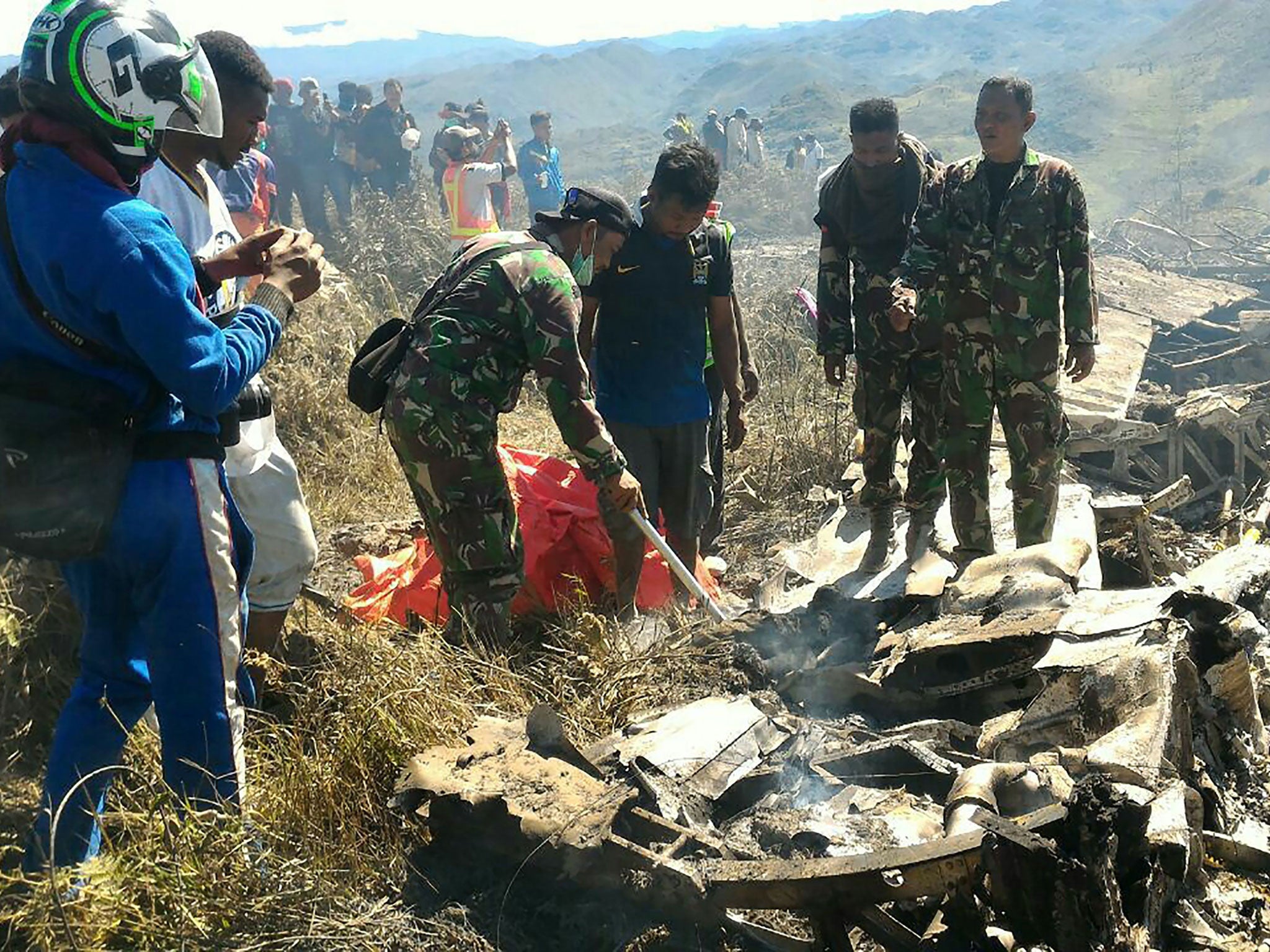 Indonesian soldiers examining the Hercules military plane A-1334 that crashed in Wamena