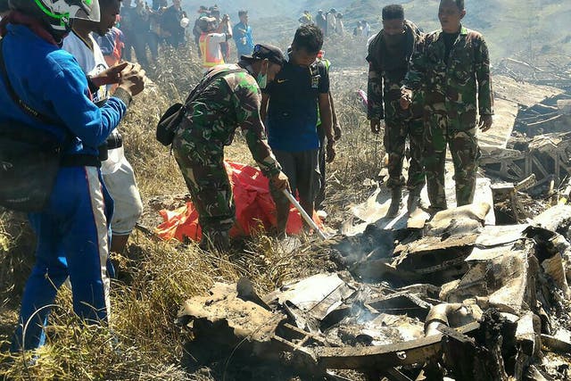 Indonesian soldiers examining the Hercules military plane A-1334 that crashed in Wamena