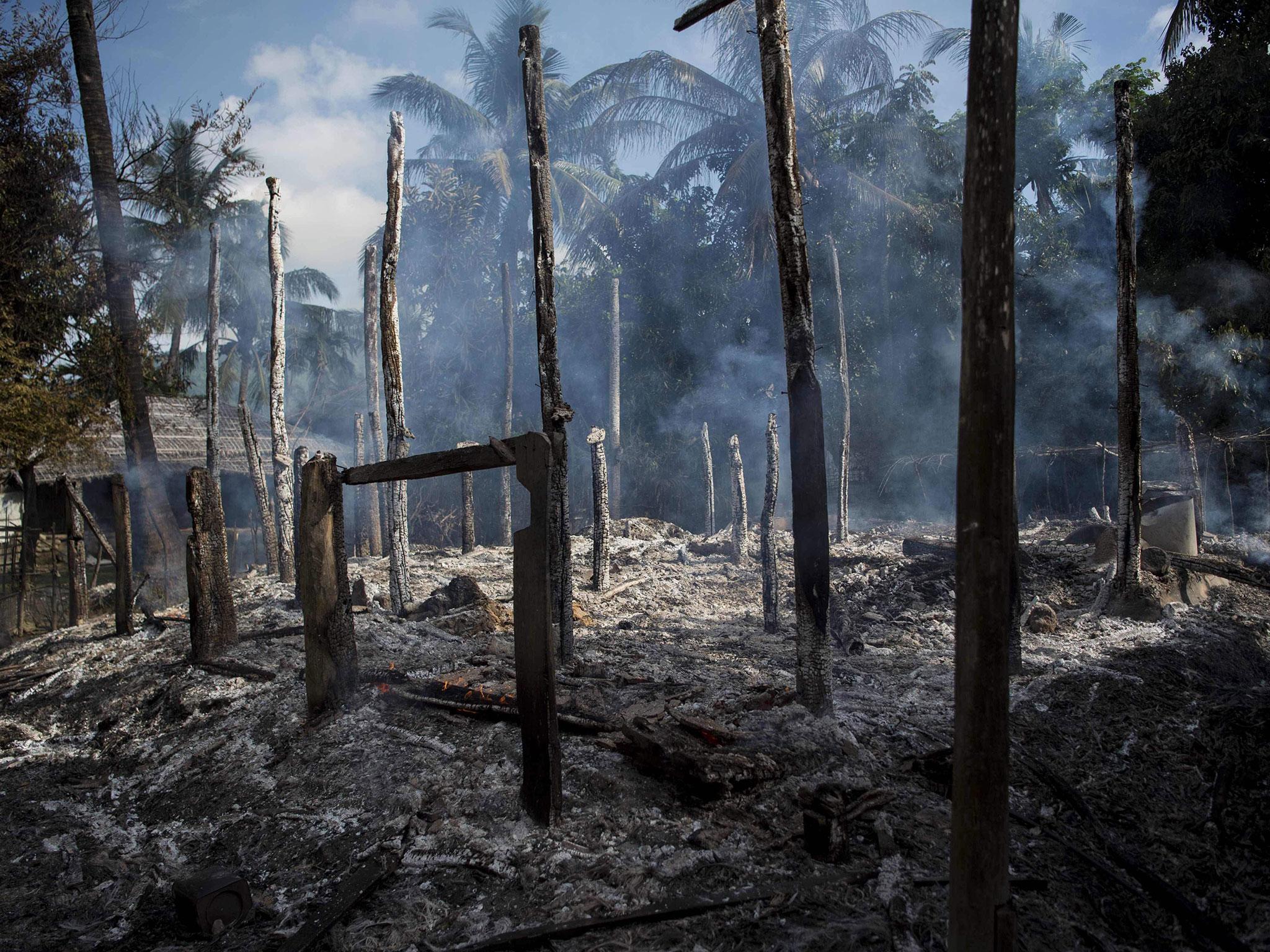 Smouldering debris of burned houses in Warpait village, a Muslim village in Maungdaw, Rakhine state, 14 October, 2016